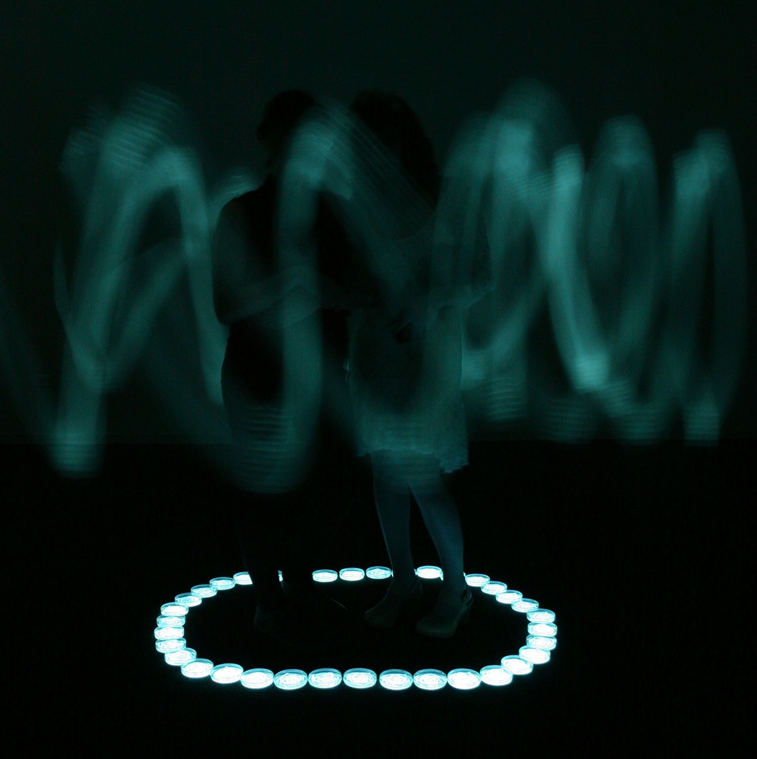 Wedding Circle, figures surrounded by a glowing circular arrangement of lights